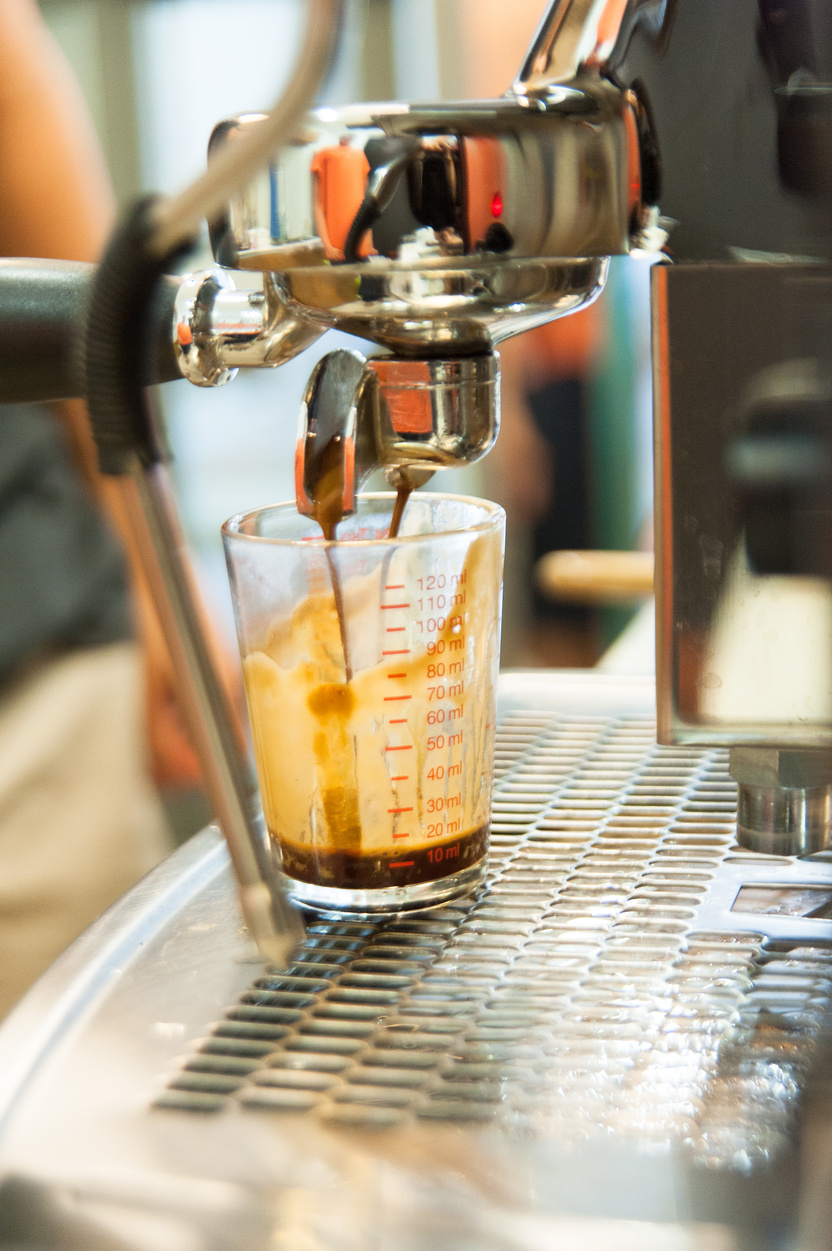 spresso machine pouring strong looking fresh coffee